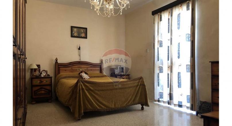 Unconverted older type apartment located in the village of Attard.
